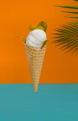 Fotobehang Ice cream with marinade and pickled cucumber in a waffle cone. Delicious summer dessert. Unusual food. Vegan food. Vertical photo with bright background © Ekaterina