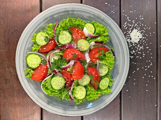 Salad of fresh tomatoes and cucumbers in a bowl