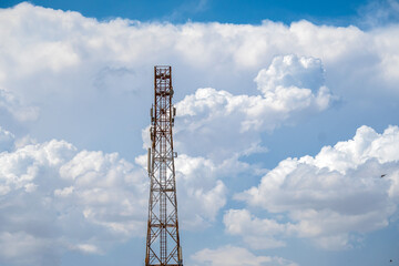 Telecommunication tower with blue sky and white cloud. Radio or satellite pole. Mobile 4g,5g network technology.