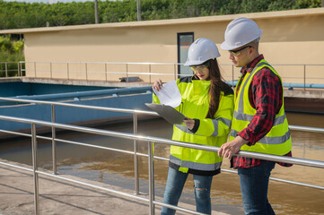 Environmental engineers work at wastewater treatment plants,Water supply engineering working at Water recycling plant for reuse,Technicians and engineers discuss work together.