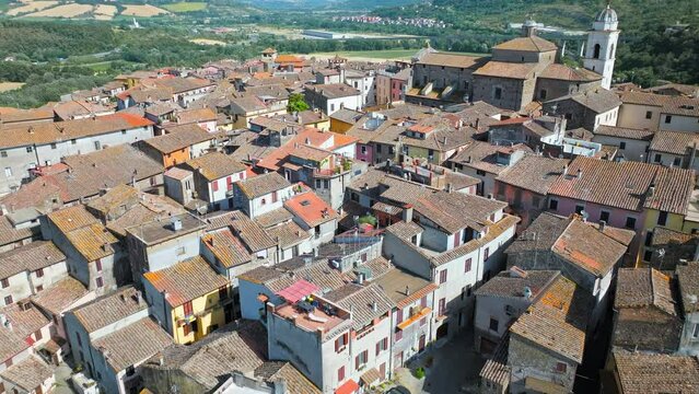 Top view of a small town in Italy with Old Colorful Italian buildings and houses. Aerial panoramic view of Orte a former Catholic bishopric and Latin titular Town in Europe on a rocky stone hill.