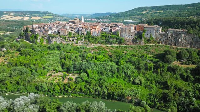 Top view of a small town in Italy with Old Colorful Italian buildings and houses. Aerial panoramic view of Orte a former Catholic bishopric and Latin titular Town in Europe on a rocky stone hill.
