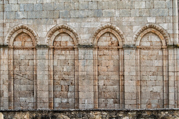 Blind pointed arches in a stone wall in the monastery of San Pedro de Arlanza in Burgos. Spain