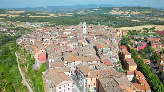 Top view of a small town in Italy with Old Colorful Italian buildings and houses. Aerial panoramic view of Orte a former Catholic bishopric and Latin titular Town in Europe on a rocky stone hill.