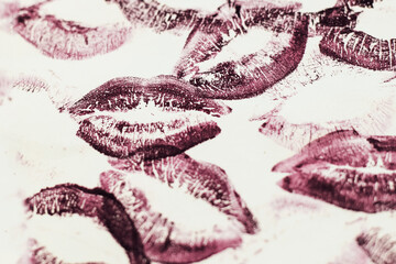 Lip prints of cosmetic lipstick on a light background.