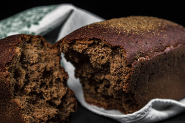 Black bread on a dark background.