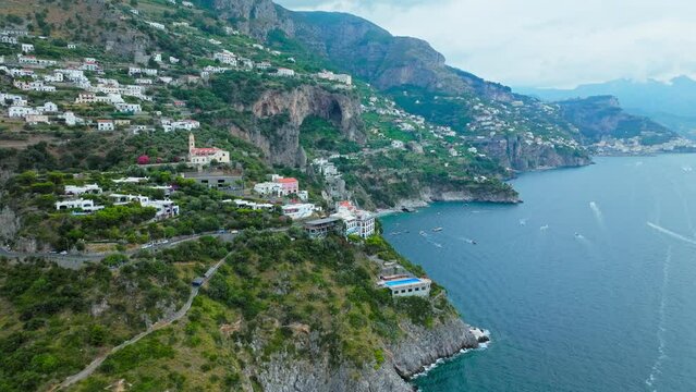 Aerial drone view of Conca dei Marini town on Amalfi Coast in Italy, Europe. Panoramic top view from above of Italian colourful houses, Chiesa San Pancrazio Martire and Torre Capo in ProRes 4K.