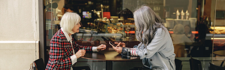Two happy women having coffee in cafe