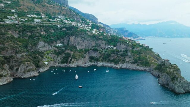 Aerial drone view of Conca dei Marini town on Amalfi Coast in Italy, Europe. Panoramic top view from above of Italian colourful houses, Chiesa San Pancrazio Martire and Torre Capo in ProRes 4K.