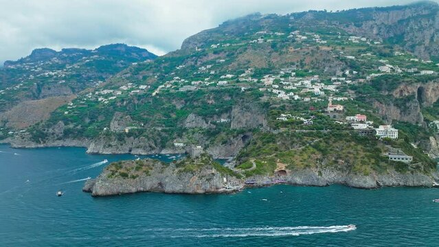 Aerial drone view of Conca dei Marini town on Amalfi Coast in Italy, Europe. Panoramic top view from above of Italian colourful houses, Chiesa San Pancrazio Martire and Torre Capo in ProRes 4K.