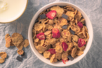 bowl of cereal with strawberries and milk