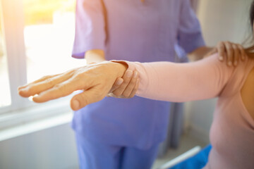 Fototapeta premium Physical therapists are helping elderly people to take care of themselves after a long period of recovery and they need regular physical therapy to help their bodies recover. physical therapy concept