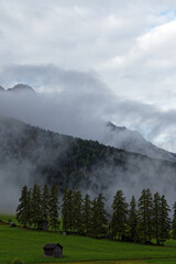 View of the peaks of the Sesto Dolomites through clouds and fog, Alps, South Tyrol, Italy, Europe