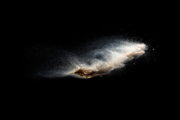Fototapeta na wymiar Sand explosion isolated on black background. Freeze motion of sandy dust splash.