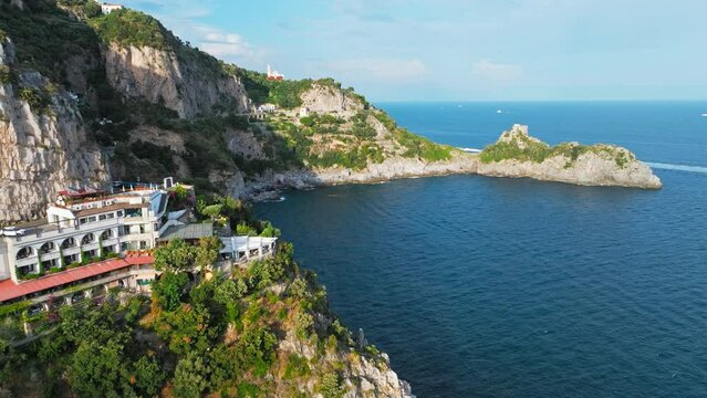 Beautiful aerial drone view of Conca dei Marini and Tovere San Pietro Villages. Top view of Amalfi Coast houses surrounded by green nature and blu Mediterranean sea.