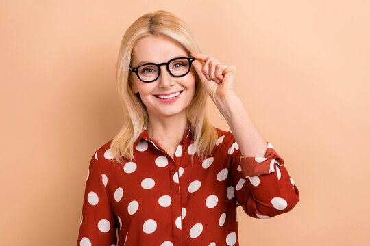Portrait of attractive pretty lady worker wear try on new eyeglasses specs oculist consultation isolated beige color background