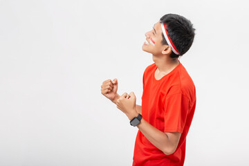 Young Indonesian man very happy and excited with arms raised celebrate Indonesia independence day...