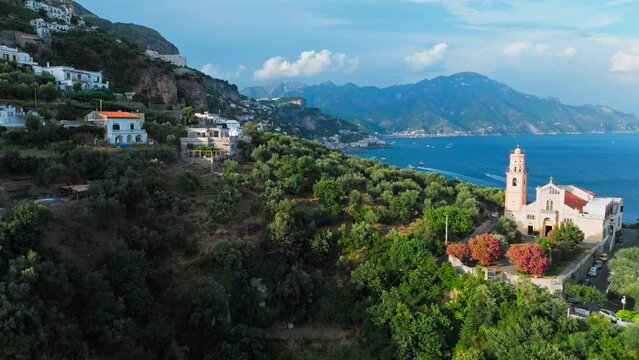 Beautiful aerial drone view of Conca dei Marini and Tovere San Pietro Villages. Top view of Amalfi Coast houses surrounded by green nature and blu Mediterranean sea.