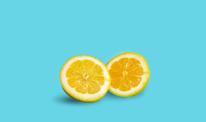 two halves of a juicy lemon close-up isolated on a blue background. creative pattern