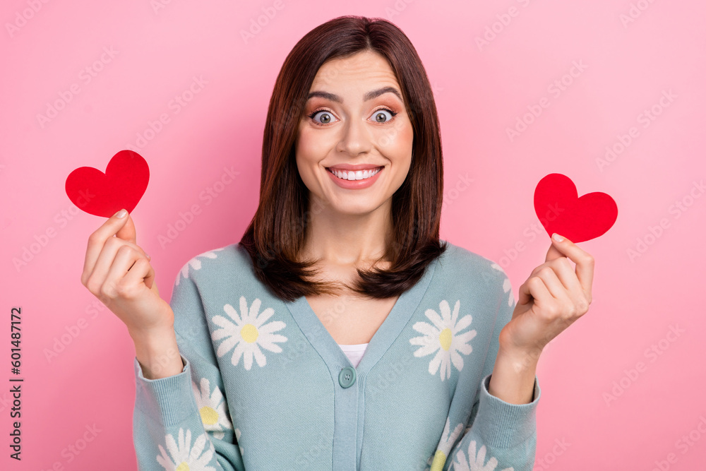 Sticker Photo of impressed excited lady wear turquoise clothes rising two red heart cards isolated pink color background