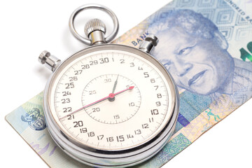 Time is money concept, stopwatch on South African money 100 rand banknote.