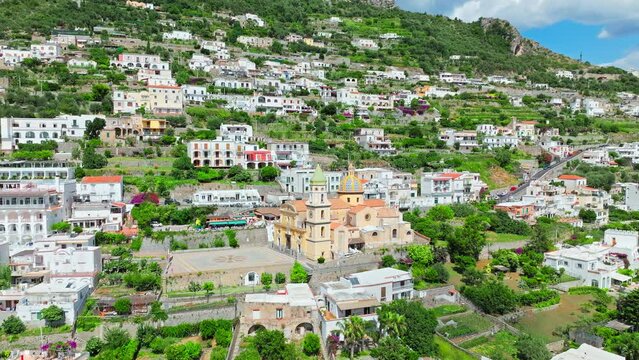 Mediterranean Town Praiano and Church of Saint Januarius, Amalfi, Italy, Europe. Aerial drone view of tourist destination town in Amalfi Coast with crystal clear sea and turquoise waters in ProRes 4K.