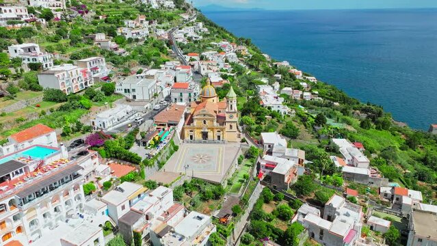 Mediterranean Town Praiano and Church of Saint Januarius, Amalfi, Italy, Europe. Aerial drone view of tourist destination town in Amalfi Coast with crystal clear sea and turquoise waters in ProRes 4K.