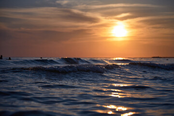 Orange-gold sunset, sky, sunlight, summer mood landscape with sea sunset on beach.