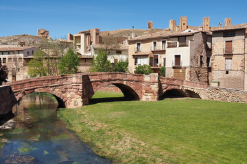 Fototapeta premium beautiful view of the roman bridge of molina de aragon with its castle in the background