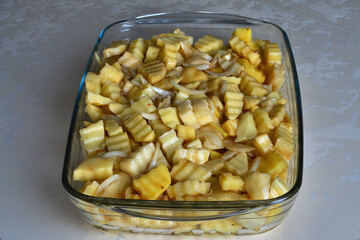 There is a potato with civet in the baking dish for cooking in the oven