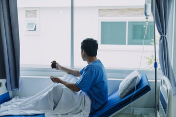 Terminally Ill Male Patient Lies on a Bad In the Hospital. Melancholy and Exhausted Patient in the...