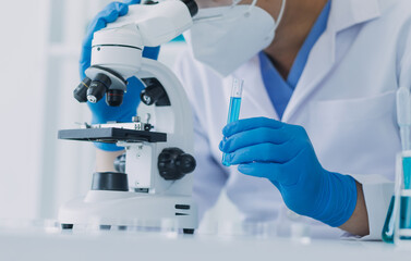 hand of scientist with test tube and flask in medical chemistry lab blue banner background