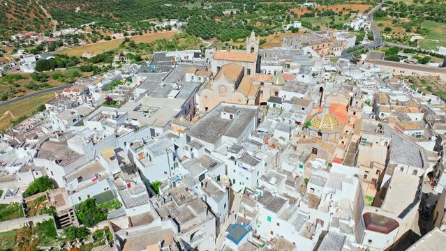View from above over Ostuni city in Italy&rsquo;s Apulia region. Close up aerial view of the Cathedral with its fascinating Byzantine, Gothic and Romanesque styles to the stunning Piazzetta Cattedrale.