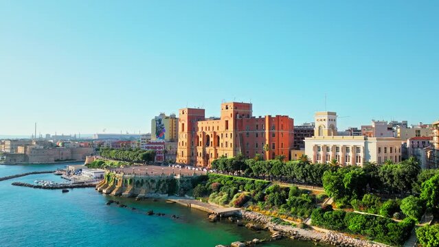 Scenic aerial view of a golden sunset over Castello Aragonese in Taranto, Italy. View from above over Bridges that link the mainland to the old town, stunning view of the European cruise port.