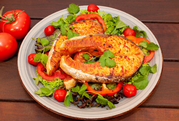 Salmon steak with vegetables in a plate