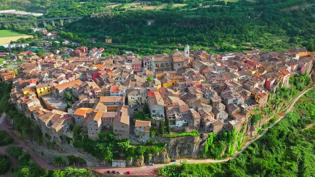 Aerial footage over the rooftops of colourful stone houses in Orte, Italy. View from above over the Catholic bishopric and Latin titular see in the province of Viterbo, in the central Italian region o