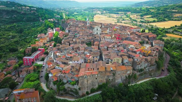 Aerial footage over the rooftops of colourful stone houses in Orte, Italy. View from above over the Catholic bishopric and Latin titular see in the province of Viterbo, in the central Italian region o