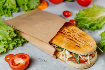 panini sandwich with crispy chicken and rucola salad