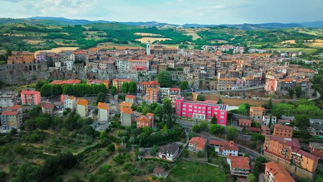 Aerial footage over the rooftops of colourful stone houses in Orte, Italy. View from above over the Catholic bishopric and Latin titular see in the province of Viterbo, in the central Italian region o