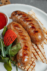Grilled tasty bratwurst sausages on the plate