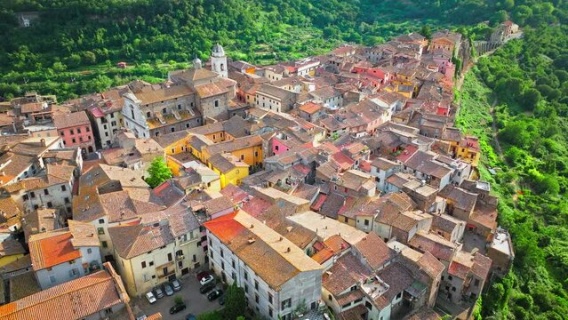 Aerial footage over the rooftops of colourful stone houses in Orte, Italy. View from above over the Catholic bishopric and Latin titular see in the province of Viterbo, in the central Italian region o