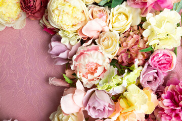 A bouquet of flowers on a pink background