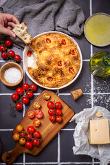 Focaccia with parmesan cheese and sweet grape tomatoes with raw tomatoes grated parmesan cheese and olive oil. 