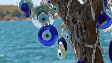 Traditional Turkish Blue Evil Eye Wishing Stones Hanging on a Tree Footage.