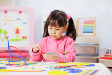 young girl was playing creative toys at home