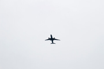 Passenger plane taking off in the dark cloudy sky