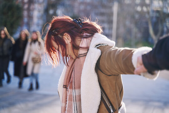 Follow me - POV. Young tourist woman holding her boyfriend by hand and walking in Madrid city at sunset. Couple on summer holiday vacation in Spain. Traveling together.