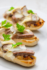 baguette baked with meat, onion and cheese
