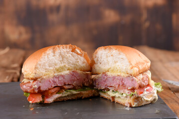hamburger sandwich with melted cheese lettuce tomato mayonnaise and bread delicious fast food traditional snack
