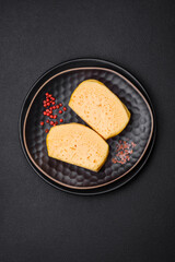 Delicious porous yellow cheese cut in large pieces on a ceramic plate